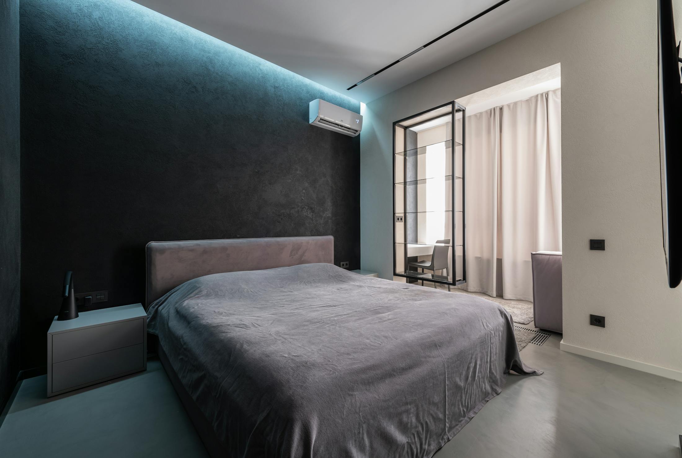 Finished wall-mounted split air-conditioning installation in a modern bedroom